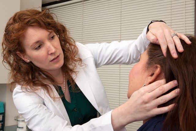 Dr. Buehler performing a facial skin exam at Pariser Dermatology